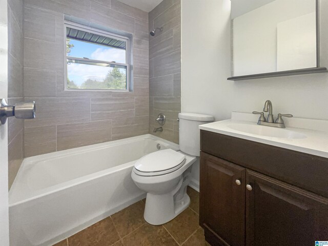 full bathroom with tiled shower / bath, vanity, toilet, and tile patterned flooring