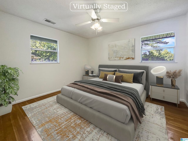 bedroom with hardwood / wood-style floors and ceiling fan