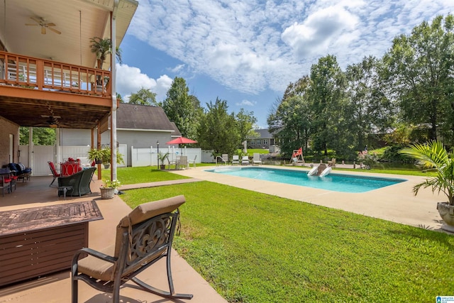 view of pool with a fenced in pool, a lawn, a patio area, ceiling fan, and fence