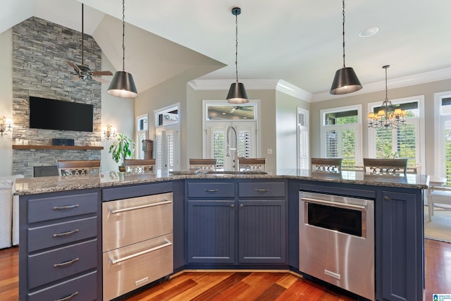 kitchen with open floor plan, pendant lighting, dark wood-style floors, a warming drawer, and a sink