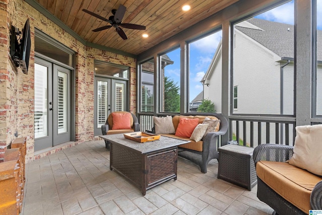 sunroom / solarium with french doors, wood ceiling, and a ceiling fan