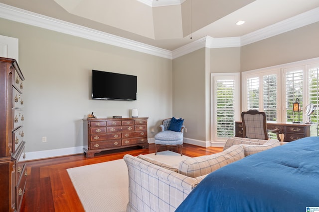 bedroom with crown molding, baseboards, and wood finished floors