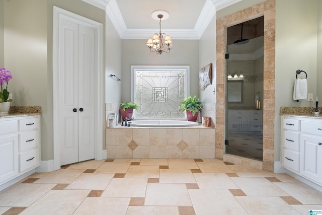 bathroom featuring ornamental molding, a stall shower, an inviting chandelier, a bath, and vanity