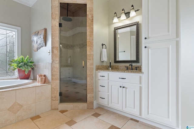 bathroom with a stall shower, vanity, crown molding, and a garden tub