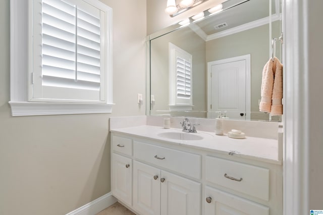 bathroom with vanity, crown molding, visible vents, and baseboards