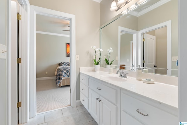 ensuite bathroom with vanity, baseboards, ensuite bath, ornamental molding, and tile patterned floors