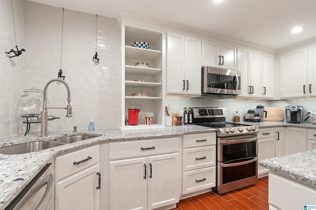 kitchen with a sink, backsplash, wood tiled floor, appliances with stainless steel finishes, and open shelves