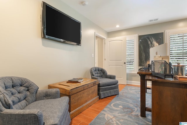 living area with recessed lighting, wood finished floors, visible vents, and plenty of natural light