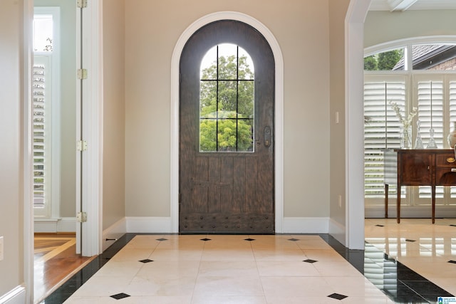 foyer entrance with tile patterned flooring and baseboards