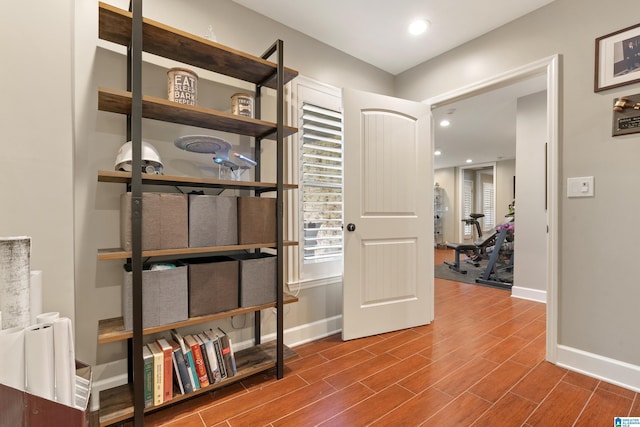 hall featuring recessed lighting, baseboards, and wood tiled floor