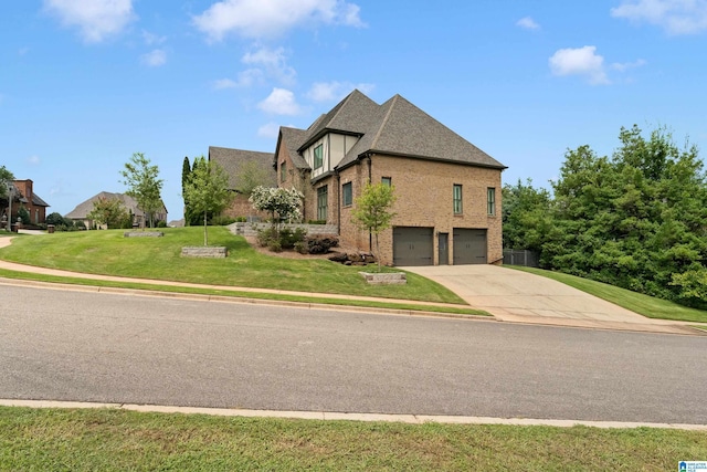 view of side of property with driveway, an attached garage, a yard, a shingled roof, and brick siding