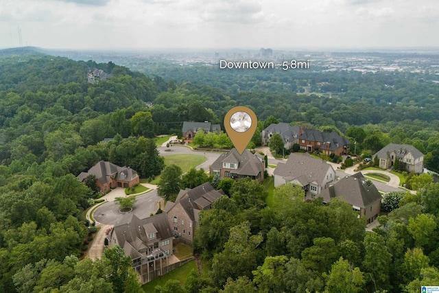 aerial view featuring a forest view and a residential view