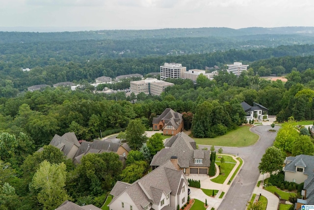 drone / aerial view featuring a forest view