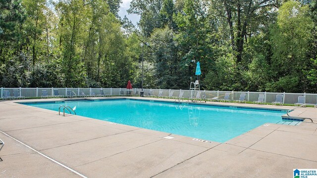 community pool featuring a patio area and fence