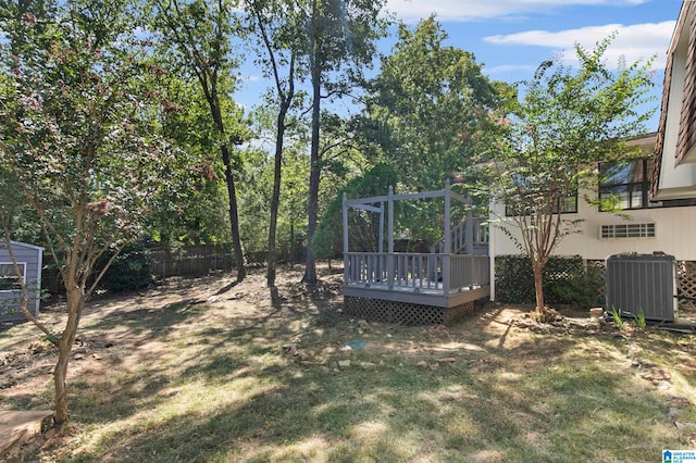 view of yard featuring central AC unit and a deck