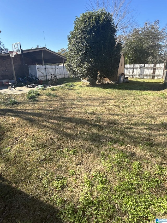 view of yard with basketball hoop