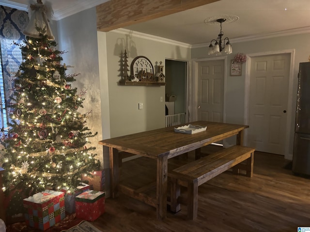 dining area with dark hardwood / wood-style floors, ornamental molding, and a notable chandelier