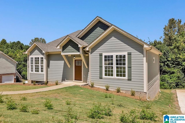 view of front of home featuring a garage and a front lawn