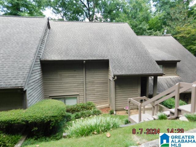 back of property with roof with shingles