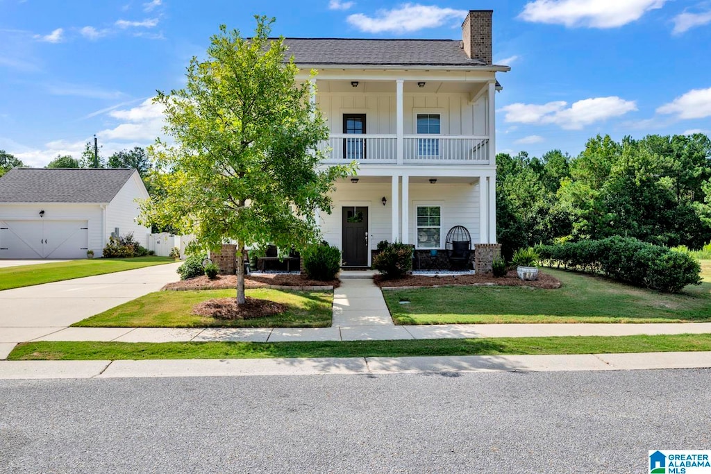 view of front of property with a front lawn, a porch, and a balcony