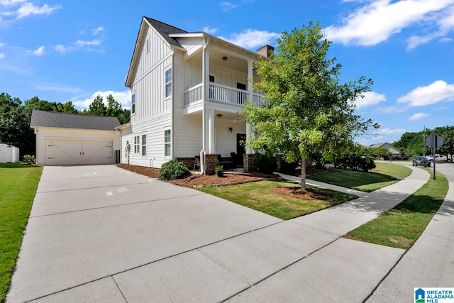 view of front of home featuring a balcony, a garage, and a front yard