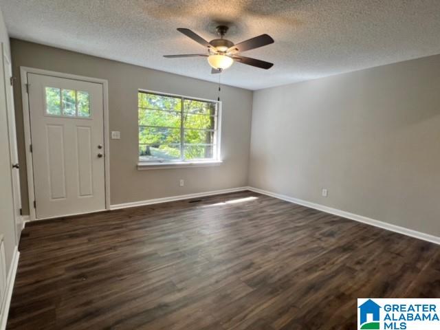 entryway featuring a textured ceiling, ceiling fan, and dark hardwood / wood-style floors