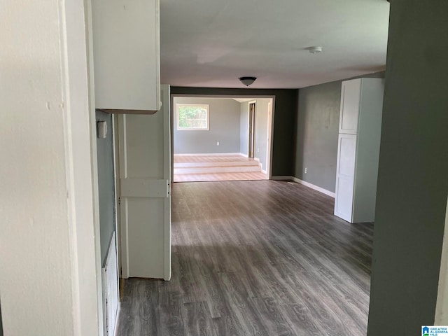 hall with dark wood-type flooring