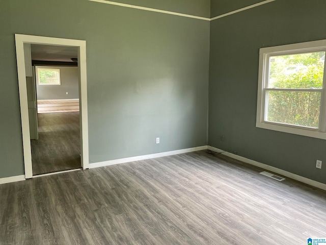 unfurnished bedroom featuring dark hardwood / wood-style floors and a closet