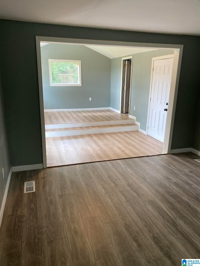 unfurnished room featuring dark wood-type flooring