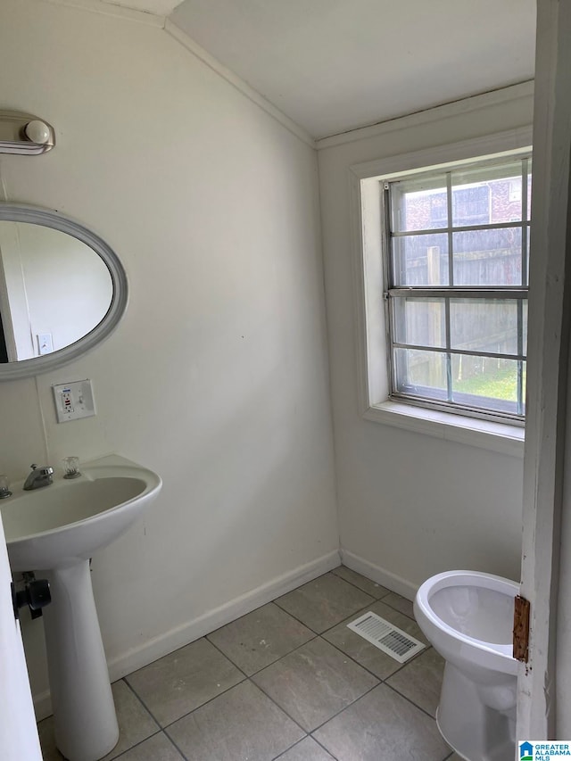 bathroom with toilet and tile patterned floors