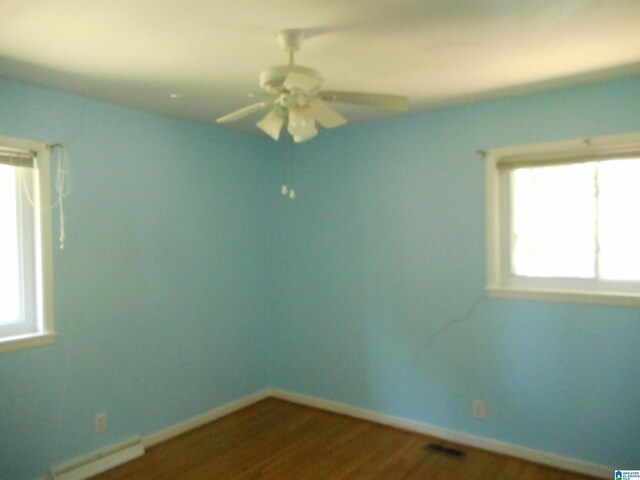 spare room with ceiling fan and wood-type flooring