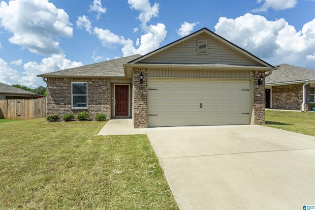 single story home featuring a garage and a front yard