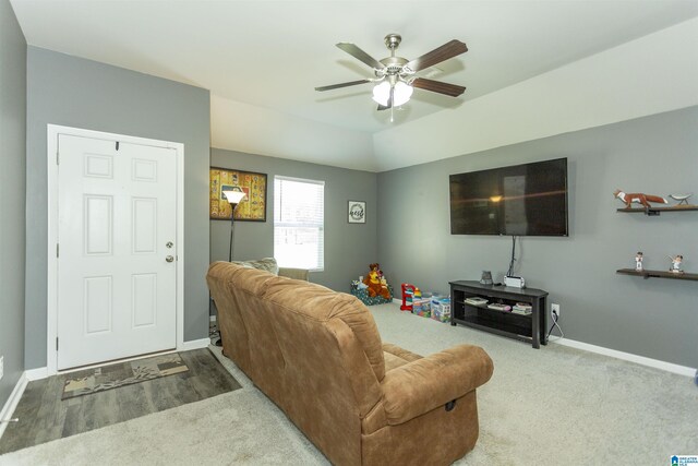 living room featuring ceiling fan and carpet