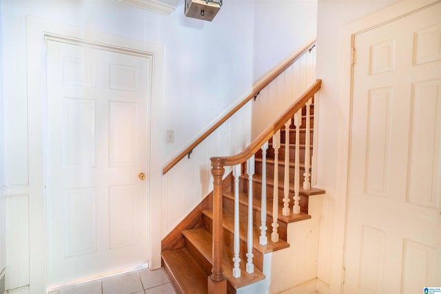 stairway with tile patterned floors