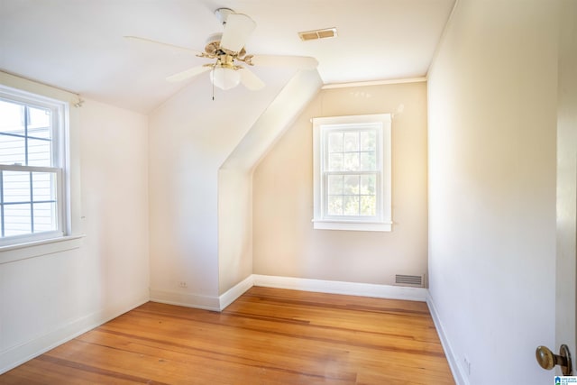 bonus room featuring ceiling fan, vaulted ceiling, light hardwood / wood-style floors, and a healthy amount of sunlight