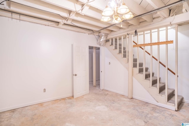 basement with an inviting chandelier