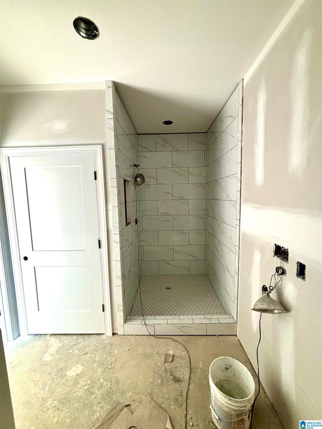 bathroom with a tile shower