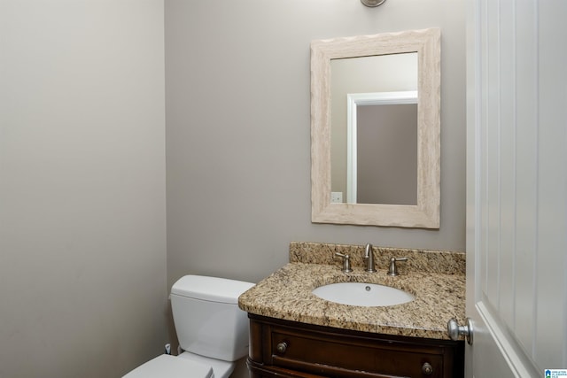 bathroom featuring toilet and vanity