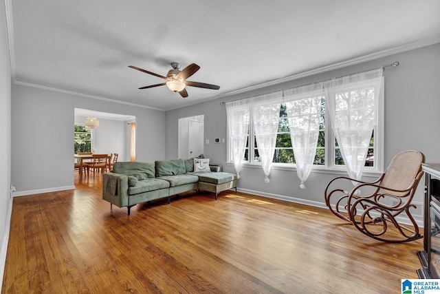 living room with ceiling fan, ornamental molding, and hardwood / wood-style flooring