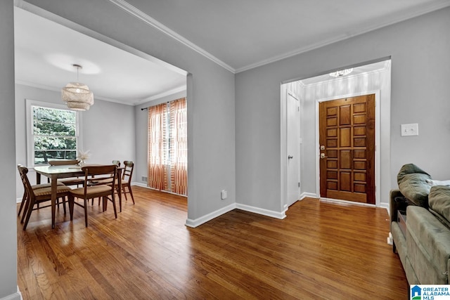 dining room with crown molding and wood-type flooring