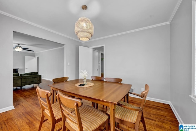 dining space featuring ceiling fan, dark hardwood / wood-style floors, and ornamental molding