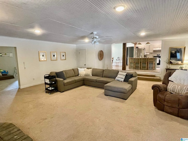 carpeted living room with ceiling fan