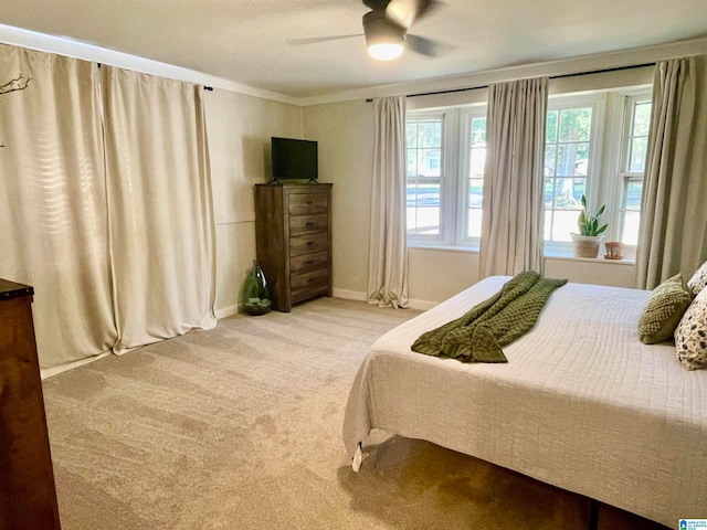 bedroom with light colored carpet and ceiling fan