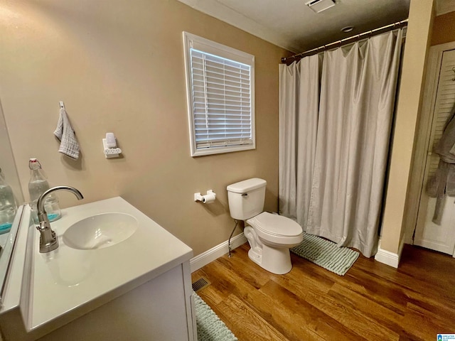 bathroom featuring walk in shower, vanity, toilet, and hardwood / wood-style floors