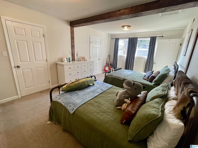 carpeted bedroom featuring a textured ceiling and beam ceiling