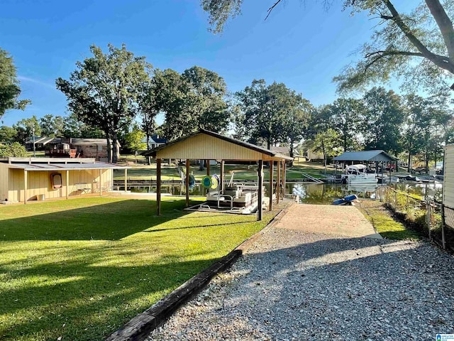 view of property's community with a water view, a yard, and a gazebo