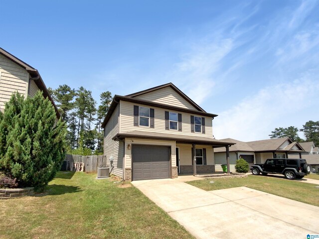 view of front facade featuring a garage, a front yard, and central AC