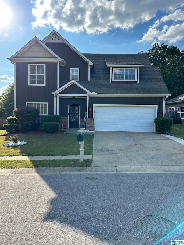 view of front of home featuring a front lawn and a garage