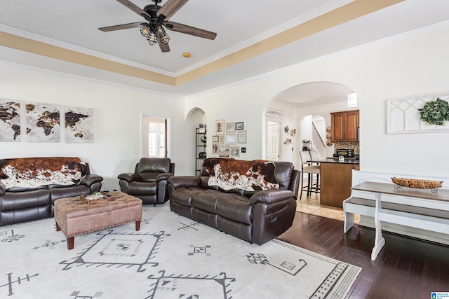 living room featuring crown molding, hardwood / wood-style flooring, and ceiling fan