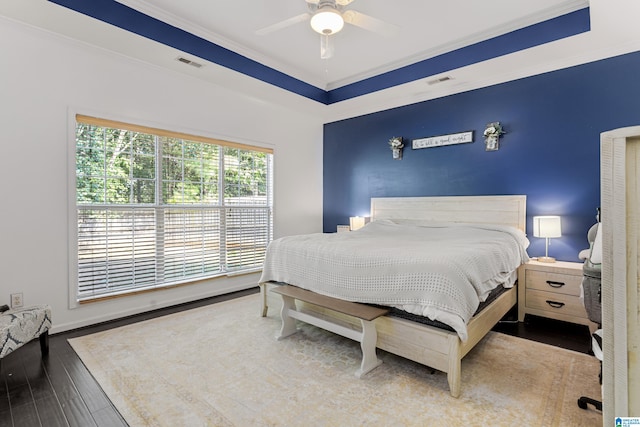 bedroom featuring ceiling fan, hardwood / wood-style flooring, and ornamental molding